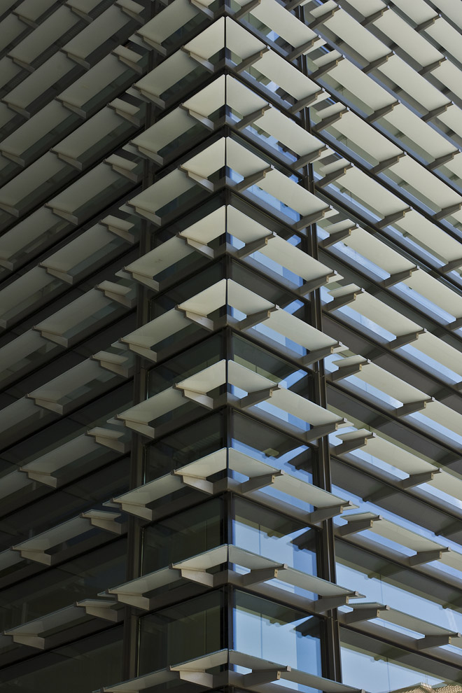glass horizontal fins join at corner of building