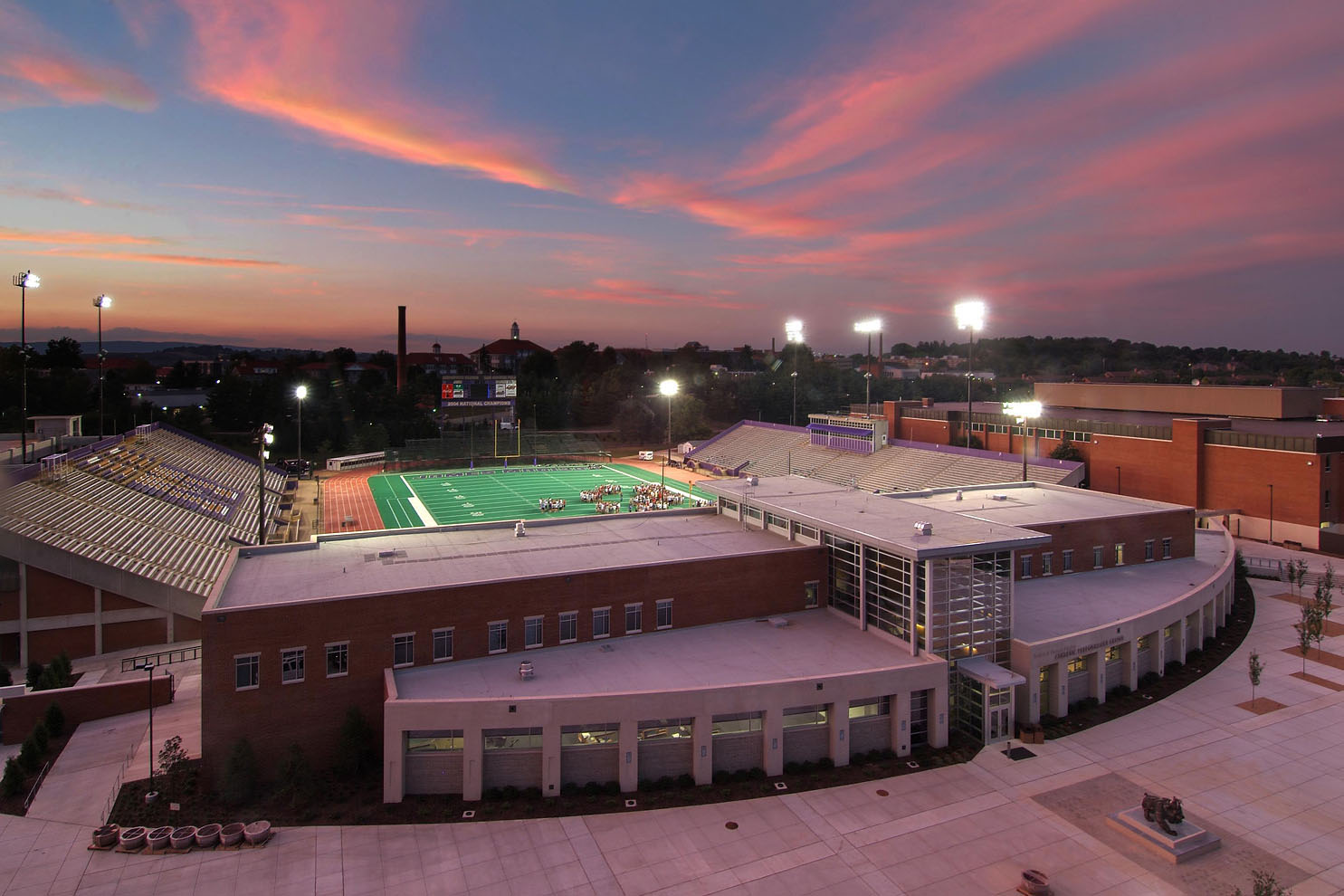twilight view of building and football field beyond