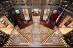 looking down to patterned tile floor and cast iron ornamental railings