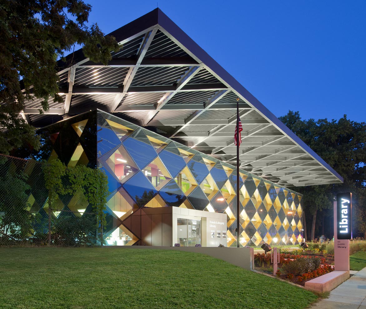 diamond-patterned library at night illuminated from within
