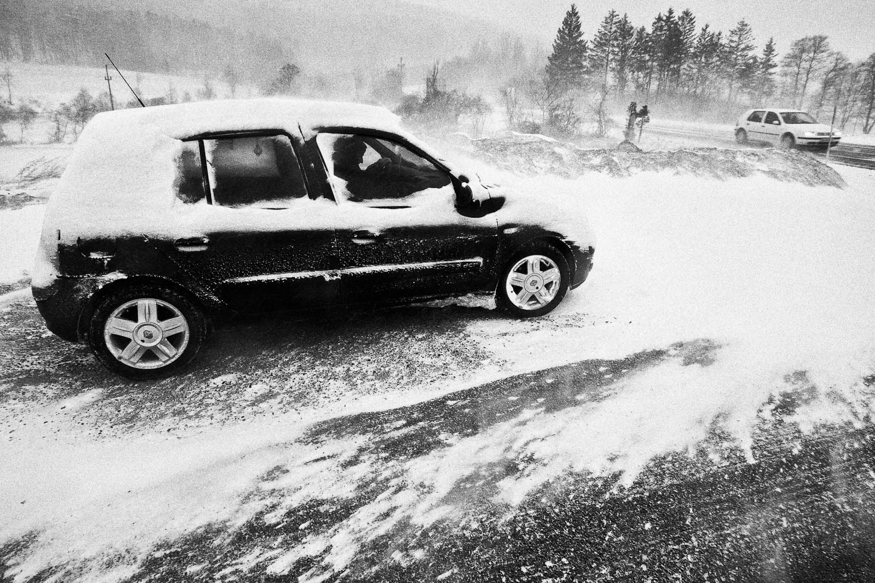 A man tries to start his car in extreme Bora wind and blizzard near Razdrto, Slovenia, on March 10, 2010.