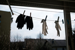 Washable protective hand gloves hang on the balcony to dry during the coronavirus outbreak nationwide lockdown in Kranj, Slovenia, on March 21, 2020.