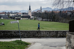 A boy wearing a protective mask walks on a stone wall in Kranj, Slovenia, during a nationwide coronavirus lockdown, on March 24, 2020.