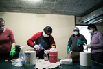 Residents of an apartment building in Kranj, Slovenia, prepare disinfectant solutions and materials during mandatory daily building disinfection on April 2, 2020.