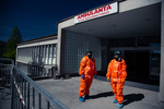 Medical personnel in hazmat suits wait at the COVID-19 testing site in Bled, Slovenia, for patients to arrive at a scheduled hour on April 16, 2020. Given the low frequency of tests in this small town, famous for its world famous tourist attraction Lake Bled, this system was put in place in order to save on protective equipment that needs to be discarded after each use.