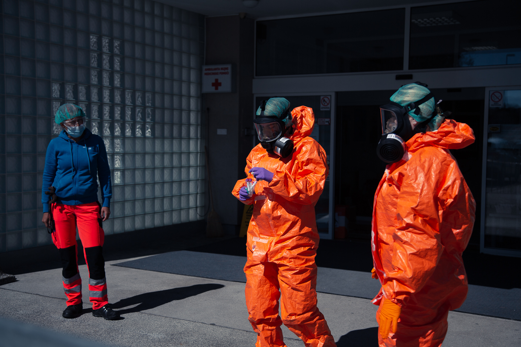 Medical personnel in hazmat suits prepare test tubes as they wait at the COVID-19 testing site in Bled, Slovenia, for patients to arrive at a scheduled hour on April 16, 2020. Given the low frequency of tests in this small town, famous for its world famous tourist attraction Lake Bled, this system was put in place in order to save on protective equipment that needs to be discarded after each use.