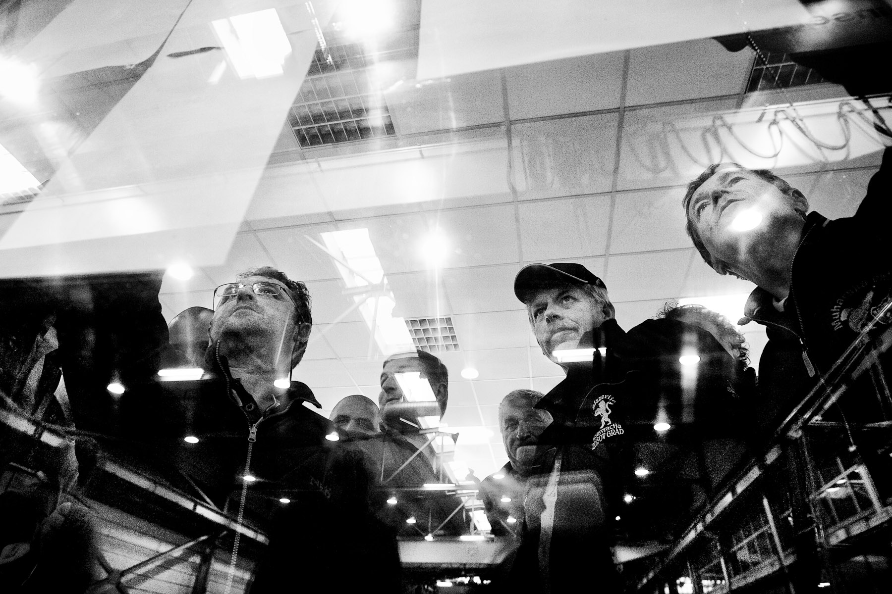 Competitors check their results on a window of a factory where the award ceremony of the National Fly Fishing Championship competition in Celje, Slovenia, took place in May 8, 2011.