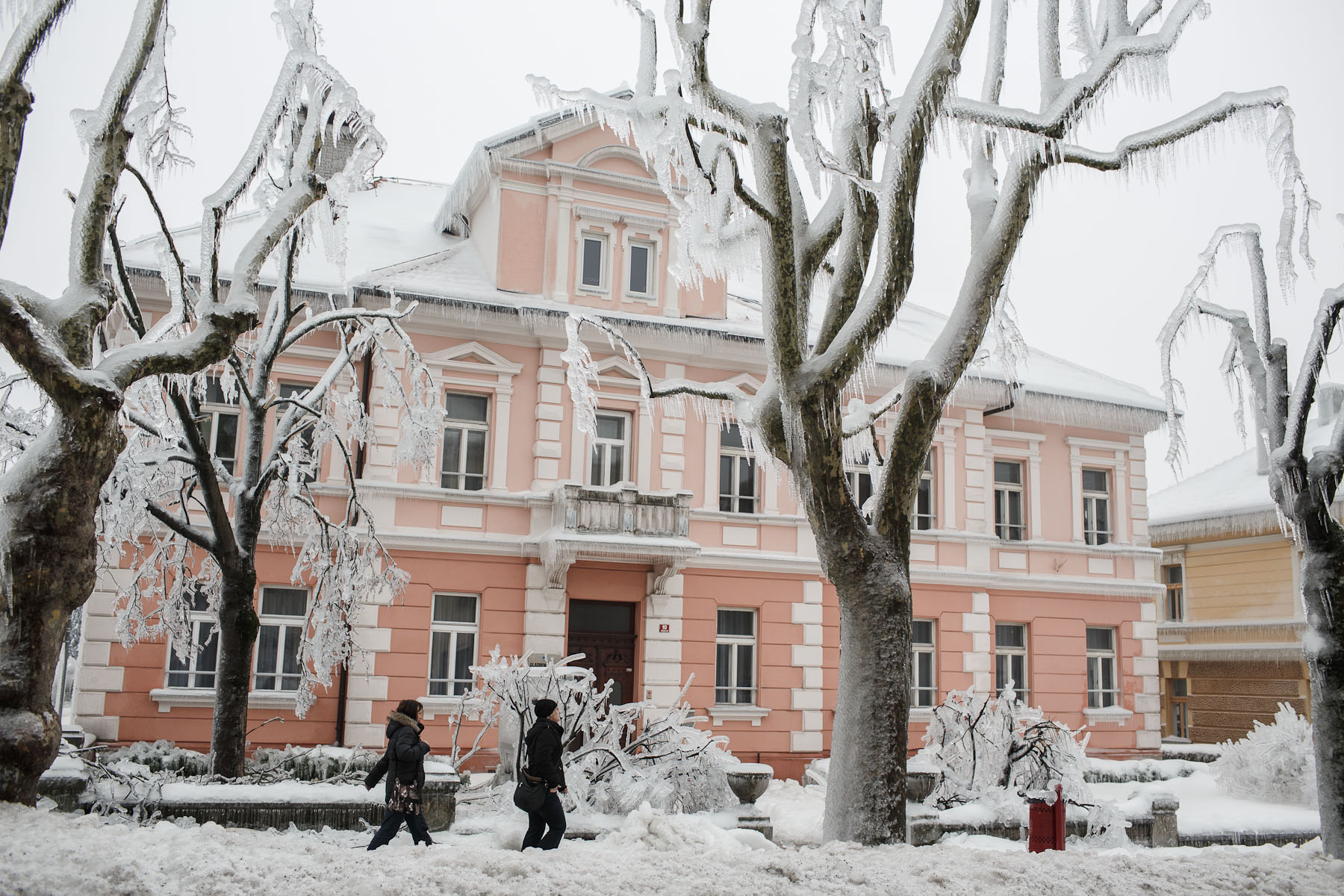 People walk down a street in the frozen town of Postojna, Slovenia, February 5 2014.