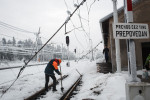 A worker clears ice from the railroad tracks on a heavy damaged train station in Postojna, Slovenia, February 5 2014.