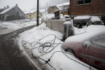 Torn-off power line cables lie around a frozen car in Postojna, Slovenia, February 5 2014.