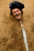 A buffoon participates in a play where people must hit his face with a wet sponge in Škofja Loka, Slovenia, on June 23, 2007.