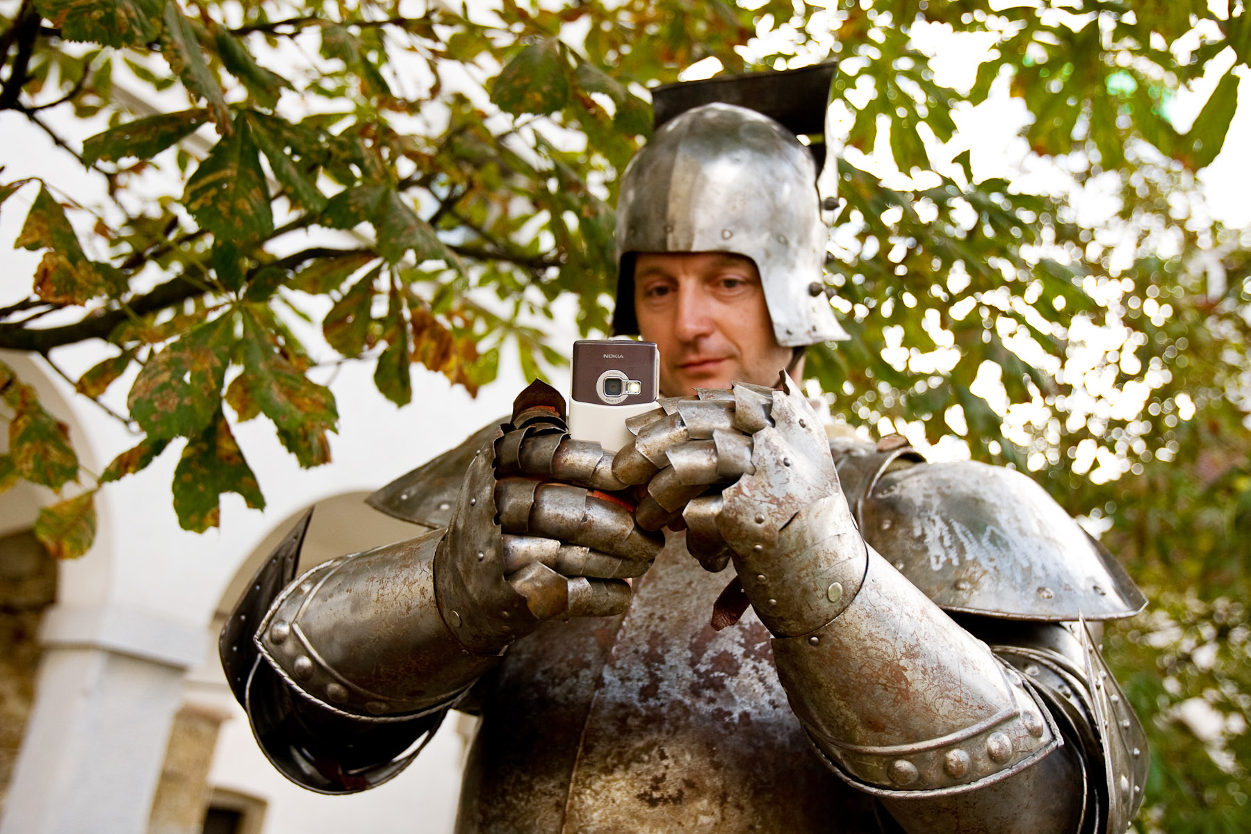 A knight takes a picture with a cell phone at the Ljubljana castle on September 9, 2007. Hiding signs of present day is extremely difficult when our culture is so dependant on technology and basic modern inventions. Cell phones are forbidden for all event participants, but it is impossible to control the large numbers of performers.