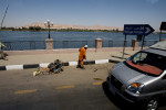 A man cleans the road that leads to one of major tourist sites in Egypt on April 28, 2008. The rise in capitalism as one of the consequences of Western influence is making the gap between the rich and the poor bigger.