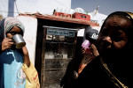 Nubian women drink water from a government funded machine in the Nubian village in Aswan, Egypt, on May 1, 2008.