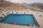 An empty hotel pool stands out of the desert mountains surrounding Petra, Jordan, on May 1, 2009.