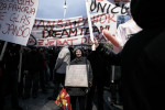 A protester carries a sign with several accusations against the government during anti-government protests in Ljubljana, Slovenia, November 30, 2012.