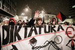 Protesters carry a large sign denouncing dictatorship of capitalism during anti-government protests on December 7 in Ljubljana, Slovenia.
