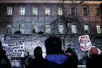 People protest outside the Maribor prisons demanding the release of protesters watching from the windows during a protest march against the mayor and the local government in Maribor, Slovenia, on December 14, 2012.