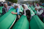 Women mourn among the lines of coffins at the Potocari cemetery in Srebrenica the day before the mass burial of 775 newly identified victims of the 1995 Srebrenica massacre.