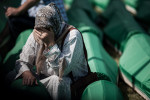 A woman cries at the coffin of a loved one at the Potocari cemetery in Srebrenica on July 11, 2010, before the memorial ceremony and mass burial of 775 newly identified victims of the 1995 Srebrenica massacre.