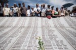Crowds of people watch the memorial ceremony at the Potocari cemetery in Srebrenica before the mass burial of 775 newly identified victims of the 1995 Srebrenica massacre on July 11, 2010.