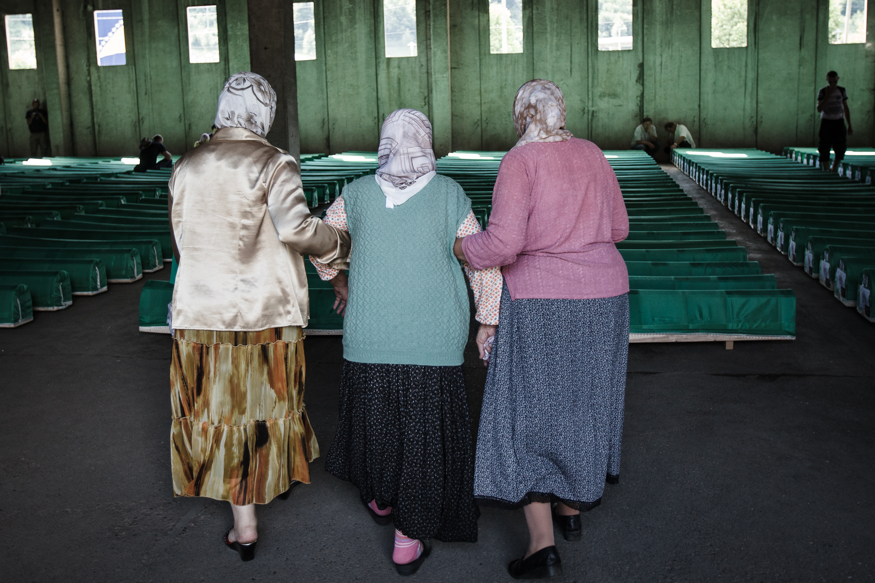 Bosnian women enter a hall full of coffins to search for their loved ones in the Potocari memorial center, Srebrenica, July 10, 2010.