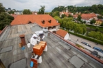 Trušnovec inspects the beehives on the roof of the Urban Planning Institute of the Republic of Slovenia in Ljubljana. Joining him is an employee who is a beginner beekeeper.