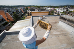 Urban beekeeper Peter Pečenko inspects beehives on the rooftop of his apartment building in Koseze.
