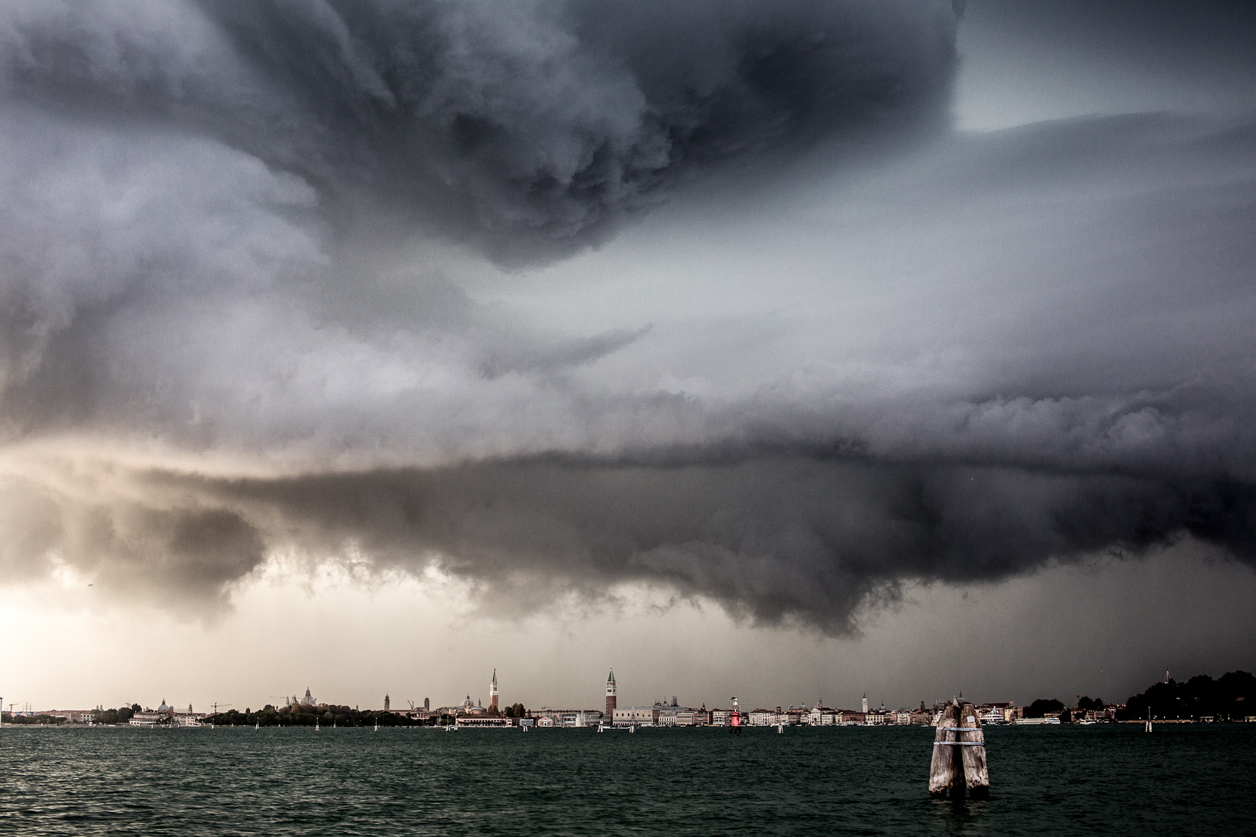 A storm looms over the city of Venice on September 26, 2012. Venice is subject to strong storms, Bora and scirocco winds that bring waves and high tides that eventually flood the city. Storms at sea and inland are especially dangerous. The open sea storms bring tides, while the inland storms bring flooding from rivers that flow into the lagoon.