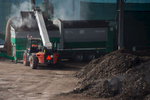 A loader dumps biomass into a sieving machine in the composting facility of RCERO Ljubljana.