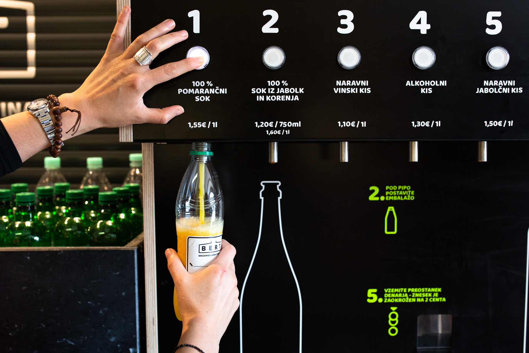 A customer uses one of two packaging-free vending machines called BERT  that offers 18 liquid products in Ljubljana, May 8, 2019. Using your own bottle or the one provided by BERT customers can buy shampoos, detergents,  juices, several types of vinegar and oil.