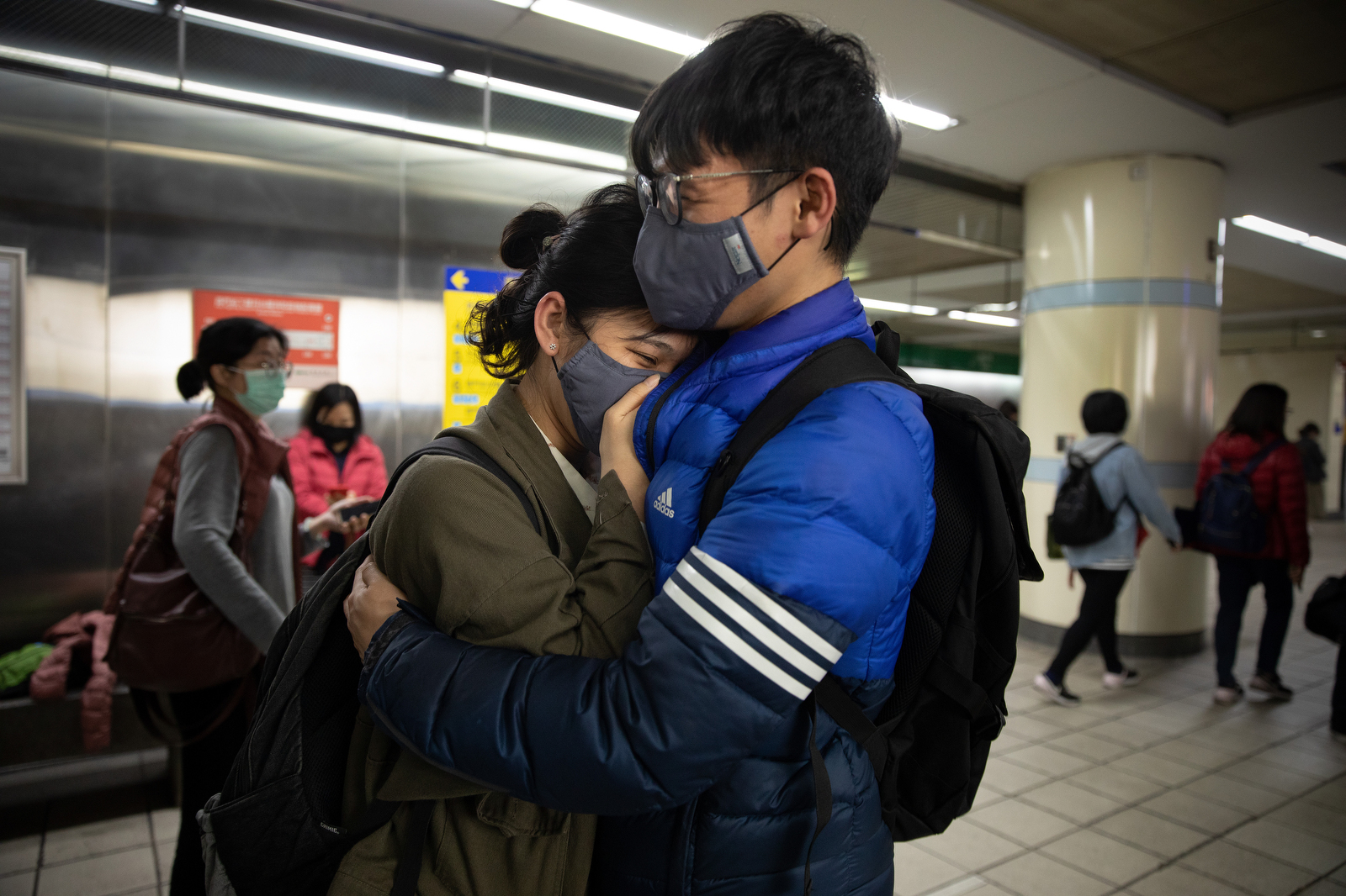 TAIPEI - MARCH 18:  A young couple embrace while waiting for a metro train in downtownTaipei, Taiwan on March 18, 2020. Taiwan, Singapore and Hong Kong have had more successful approaches in battling the pandemic given their experience with SARS in 2003. According to CDC current totals the Coronavirus ( COVID-19) has now effected 235,939 globally, killing 9,874. It has spread to 157 countries. (Photo by Paula Bronstein/Getty Images )BANGKOK - MARCH  :  in Taipei, Taiwan on March 19, 2020. According to CDC current totals the Coronavirus ( COVID-19) has now effected 235,939 globally, killing 9,874. It has spread to 157 countries. (Photo by Paula Bronstein/Getty Images )BANGKOK - MARCH  :  in Taipei, Taiwan on March 19, 2020. According to CDC current totals the Coronavirus ( COVID-19) has now effected 235,939 globally, killing 9,874. It has spread to 157 countries. (Photo by Paula Bronstein/Getty Images )