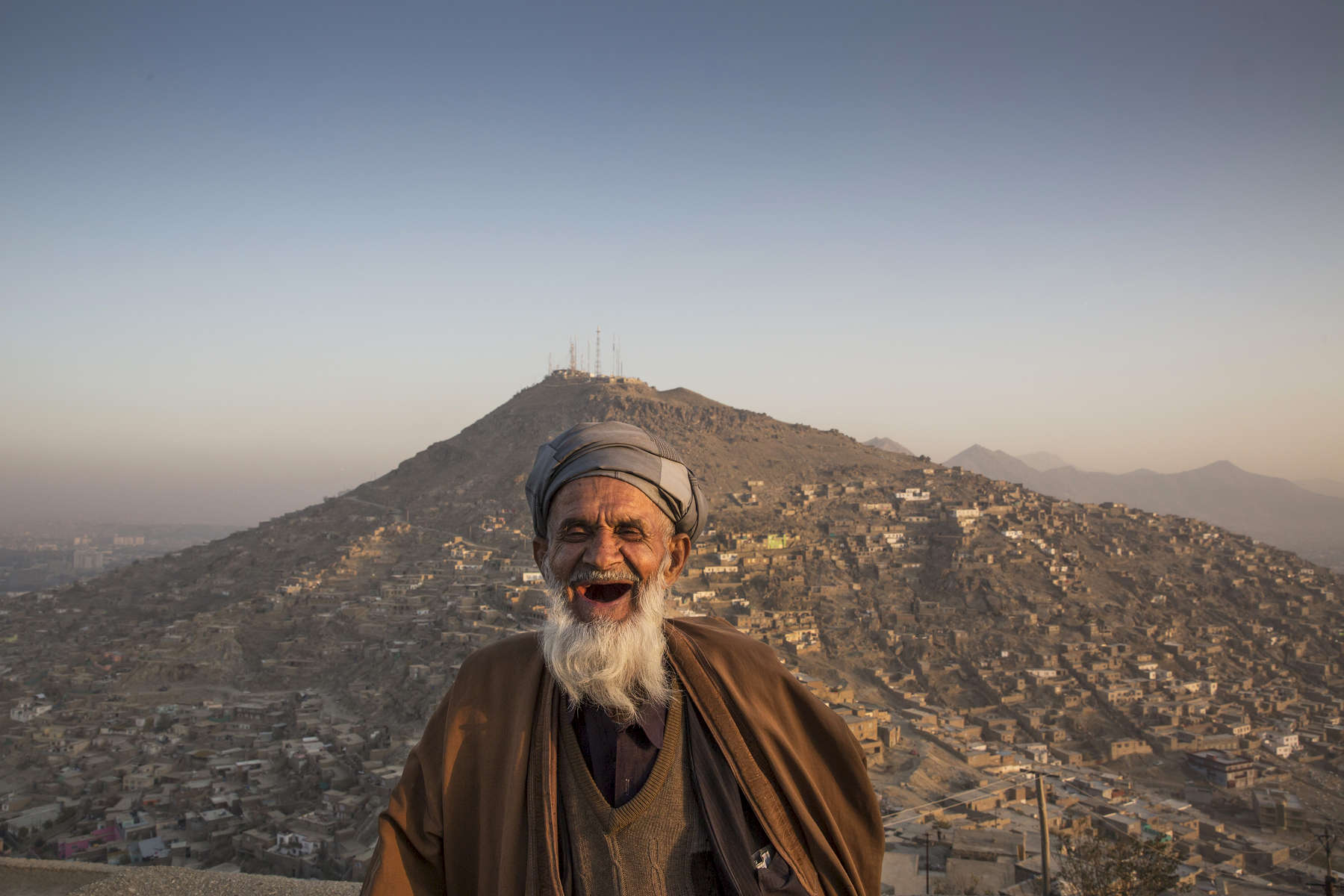 Eid Muhammad, 70 stands on the balcony overlooking the hills of Kabul.  Millions of Afghans live in informal settlements occupied without a formal deed, on land with unclear legal ownership. This lack of a functioning land management system, Afghan and international experts say, looms as one of the most serious obstacles to the country’s economic development.Nov.21, 2014 Paula Bronstein/ The Wall Street Journal