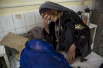 Sangina, mourns as she is told her grand daughter won\'t survive.  Critical ill  Fauzia is 8 years, in a coma with Meningitis and Tuberculosis  in the Pediatric Intensive Care Unit  at Boost hospital in Lashkah Gar, Afghanistan. Fauzia\'s mother died six months prior from complications due to child birth. June 22, 2014