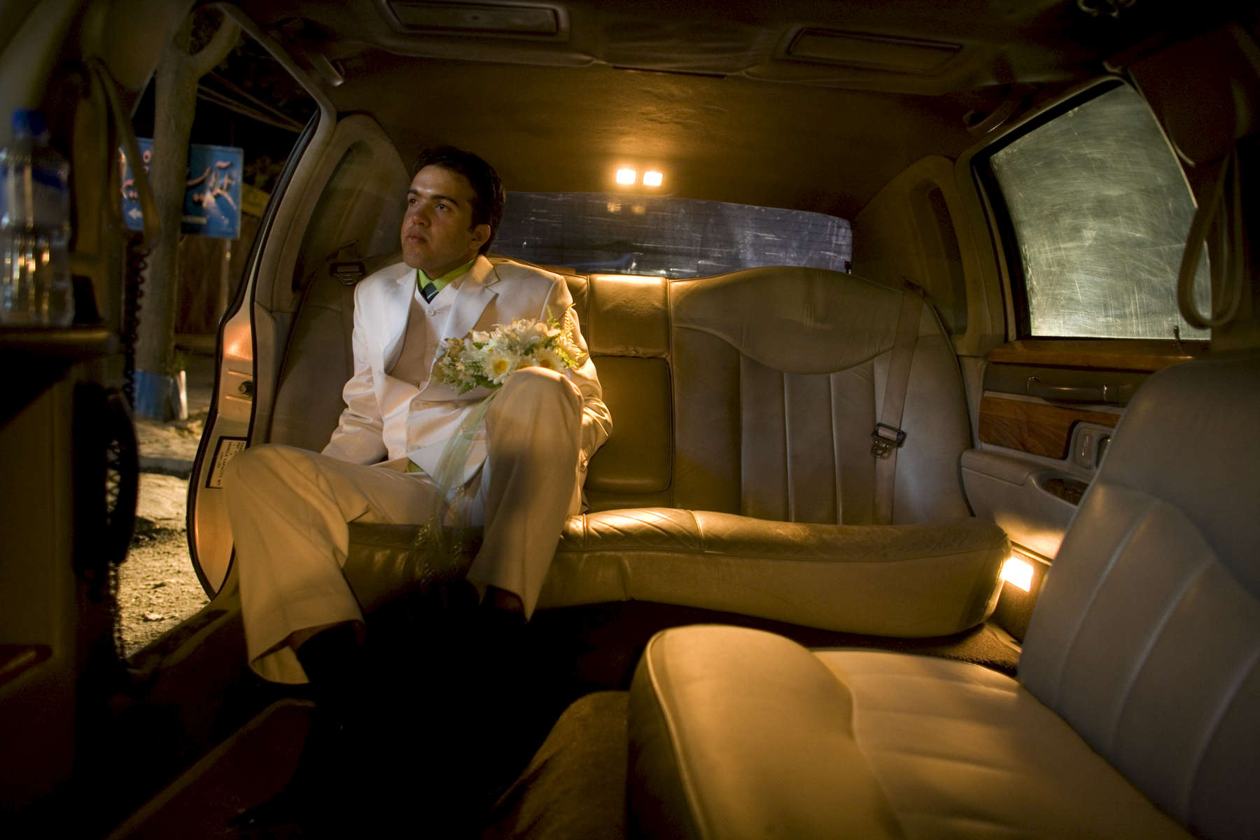 KABUL-AFGHANISTAN-JULY 31: Afghan groom Qais Habibi,19, patiently waits inside a Lincoln limousine for his new bride to finish getting ready at the bridal salon in Kabul July 31, 2007 Afghanistan. Shams Limousine is busy on most days during the busy wedding season renting for 150 USD for 10 hours, shipped from Los Angeles are renting for what he believes is the lowest rate in the world. 