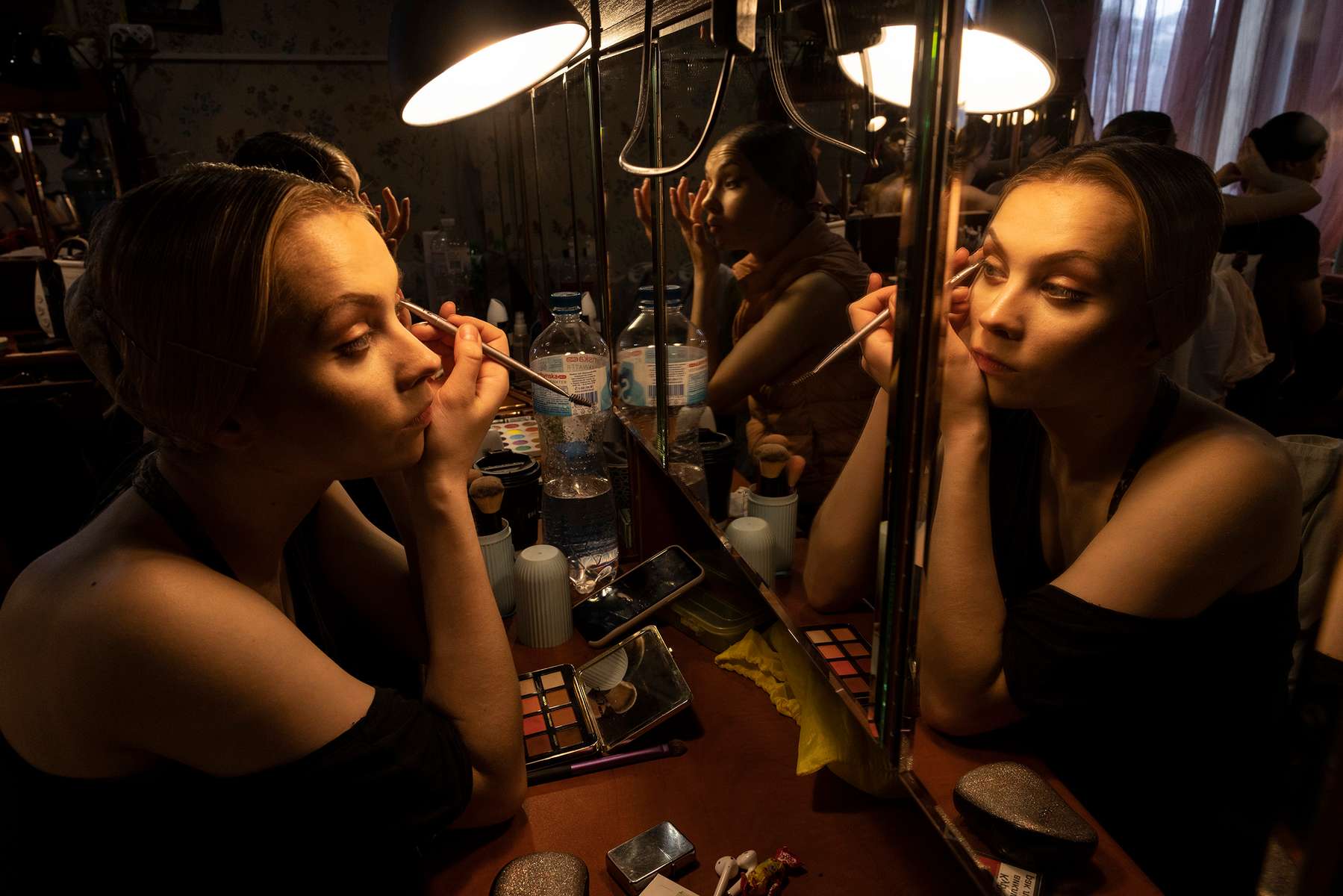 LVIV, UKRAINE - Ballet dancer Romana Pumanska puts on makeup backstage for the performance of Giselle June 10, 2022 in Lviv, Ukraine. The Lviv National Opera house started performances last month for both ballet and opera.The bomb shelter can only hold 300 people so tickets are limited incase a siren goes off during the performance. (Photo by Paula Bronstein /Getty Images)