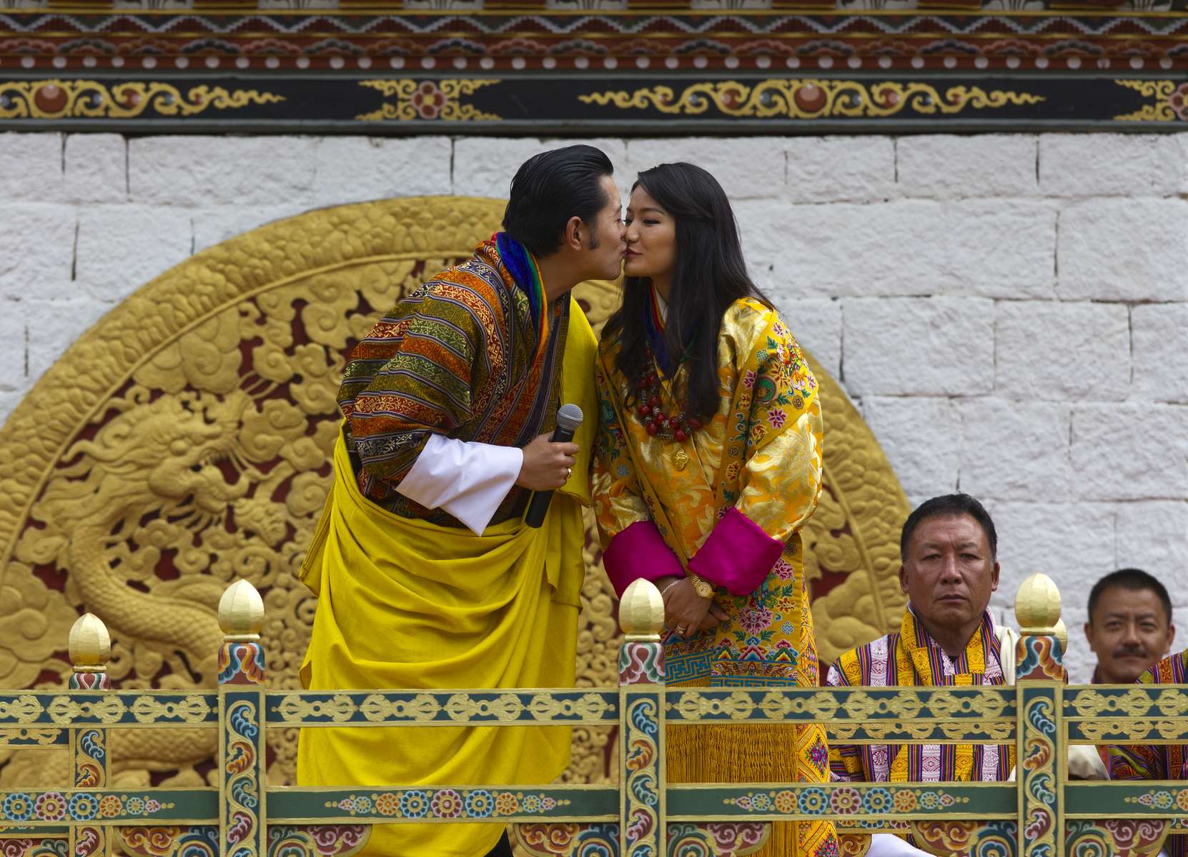 THIMPHU, BHUTAN - OCTOBER 15: The Royal couple King Jigme Khesar Namgyel Wangchuck and Queen of Bhutan Ashi Jetsun Pema Wangchuck kiss in front of thousands of Bhutanese citizens at the celebration ground at ChangLeme Thang on October 15, 2011 in Thimphu, Bhutan. Today marked the third and final day of celebrations for the royal wedding with singing and dancing. (Photo by Paula Bronstein /Getty Images)