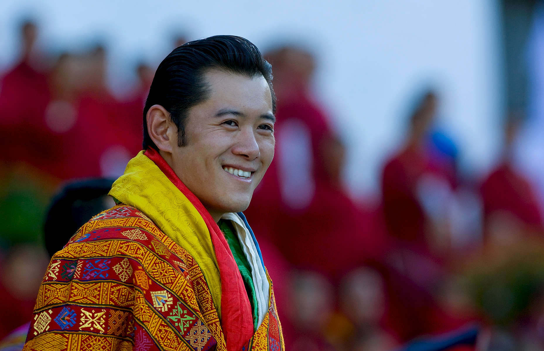 THIMPHU, BHUTAN -NOV 6, 2008: His Majesty Jigme Khesar Namgyel Wangchuck, 28, smiles towards his people at the ceremonial grounds of The  Tendrey Thang November 6, 2008 in Thimphu, Bhutan. The young Bhutanese king, anOxford-educated bachelor became the youngest reigning monarch on the planet today. He was handed the Raven Crown by his father, the former King Jigme Singye Wangchuck, in an ornate ceremony in Thimpu, the capital. The tiny Himalayan kingdom, a Buddhist nation of 635,000 people is wedged between China and India .  (Photo by Paula Bronstein/Getty Images) 