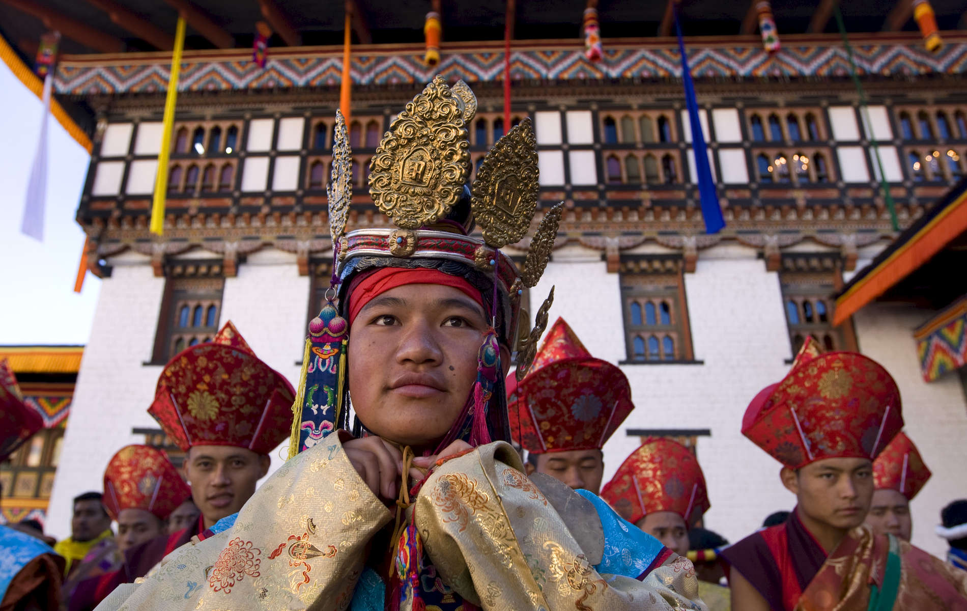 THIMPHU, BHUTAN -NOV 6, 2008: Bhutanese ceremonial dancers stand in line as the coronation ceremony begins November 6, 2008 in Thimphu, Bhutan. Jigme Khesar Namgyel Wangchuck, 28, the young Bhutanese king,  became the youngest reigning monarch on the planet today. He was handed the Raven Crown by his father, the former King Jigme Singye Wangchuck, in an ornate ceremony in Thimpu, the capital. The tiny Himalayan kingdom, a Buddhist nation of 635,000 people is wedged between China and India .  (Photo by Paula Bronstein/Getty Images) 