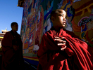 THIMPHU, BHUTAN -NOV 6, 2008: Bhutanese monks stand next to a large Thangkha painting at the Dratshang Kuenra Tashichho Dzong waiting for His Majesty Jigme Khesar Namgyel Wangchuck to arrive for the Coronation ceremony November 6, 2008 in Thimphu, Bhutan. The young Bhutanese king, anOxford-educated bachelor became the youngest reigning monarch on the planet today. He was handed the Raven Crown by his father, the former King Jigme Singye Wangchuck, in an ornate ceremony in Thimpu, the capital. The tiny Himalayan kingdom, a Buddhist nation of 635,000 people is wedged between China and India .  (Photo by Paula Bronstein/Getty Images) 
