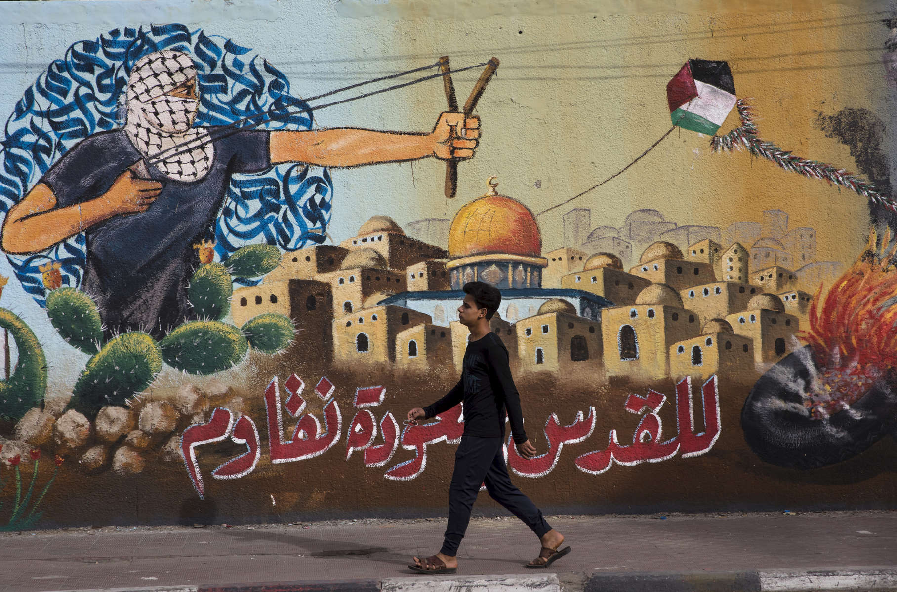 GAZA CITY, GAZA STRIP- MAY 22,2018A man walks by a mural depicting the struggle for freedom May 22,2018 in Gaza city, Gaza strip. The world’s largest open air prison along the Israel-Gaza border. Everyone is well aware that Gaza's two million inhabitants are trapped in a cycle of violence and poverty, created by policies and political decisions on both sides. The problems and complications affecting Gaza today are overwhelming. The world, seemingly accustomed to the suffering of the Gazan people turns a blind eye. (Photo by Paula Bronstein ) 