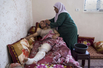 GAZA CITY, GAZA STRIP- MAY 25,2018 : Dawlat Fawzi Hamadin, 33, from Beit Hanoun, gets washed by her mother on May 25, 2018 in Gaza. She was shot on May 14th,  damaging the main artery of the heart with severe tissue damage. Dawlat was pronounced dead, then after an operation that lasted for seven hours she survived. She is the only breadwinner of the family and worked as a hairdresser. Everyone is well aware that Gaza's two million inhabitants are trapped in a cycle of violence and poverty, created by policies and political decisions on both sides. The problems and complications affecting Gaza today are overwhelming. The world, seemingly accustomed to the suffering of the Gazan people turns a blind eye. (Photo by Paula Bronstein ) 