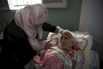 BEIT LAHIA, GAZA STRIP- MAY 27,2018Fadel Al-Zain, 70, is taken care of by his daughter Hana' Al-Zain on May 27,2018 in Beit Lahia, Gaza strip. He was injured in height of the 2014 offensive when bombing hit near his home. He is now paralyzed, quadriplegic, and can't function on his own after he suffered internal bleeding in his brain.The world’s largest open air prison along the Israel-Gaza border. Everyone is well aware that Gaza's two million inhabitants are trapped in a cycle of violence and poverty, created by policies and political decisions on both sides. The problems and complications affecting Gaza today are overwhelming. The world, seemingly accustomed to the suffering of the Gazan people turns a blind eye. (Photo by Paula Bronstein ) 
