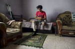 GAZA CITY, GAZA STRIP- MAY 23,2018: Iyad Manar Al-Dawhid, 28, prays in his home on May 23,2018 in Gaza city, Gaza strip. Iyad was injured again on April 7th at the protest when a bullet hit his prosthesis, injuring his other leg. He had his left leg amputated in a car accident in 2011. According to the International Committee of the Red Cross (ICRC), 13,000 Palestinians were wounded (as of June 19, 2018), the majority severely, with some 1,400 struck by three to five bullets. No Israelis were physically harmed during this time period, Israel's use of deadly force was condemned during the UN general assembly on June 13 th along with other human rights organizations.Everyone is well aware that Gaza's two million inhabitants are trapped in a cycle of violence and poverty, created by policies and political decisions on both sides. The problems and complications affecting Gaza today are overwhelming. The world, seemingly accustomed to the suffering of the Gazan people turns a blind eye. (Photo by Paula Bronstein ) 