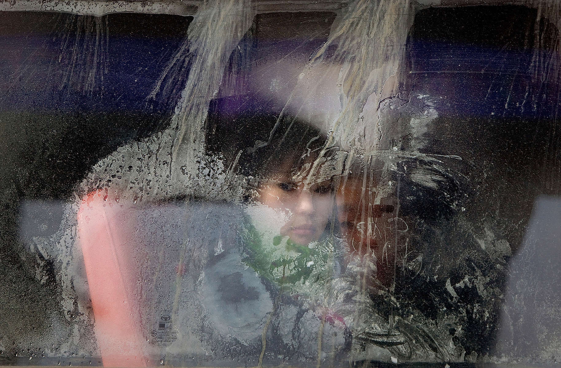 ULAAN BAATAR, MONGOLIA-MARCH 6 : A Mongolian boy looks out from a frosty window on a city bus March 6, 2010  in Ulaan Baatar, Mongolia.  Mongolia is still experiencing one of the worst Winters in 30 years. Presently the government has declared an emergency requiring foreign aid to alleviate the impact of the {quote} Zud{quote} ( Mongolian term for a multiple natural disaster) caused by bitter cold and thick snow. Recently, the UN allocated $3.7 million for humanitarian assistance to Mongolia from its Central Emergency Response Fund (CERF). Currently 1.5 m goats, 921,000 sheep, 169,000 cows and yaks, 89,000 horses and 1,500 camels had died according to the various UN agency reports. (Photo by Paula Bronstein /Getty Images)
