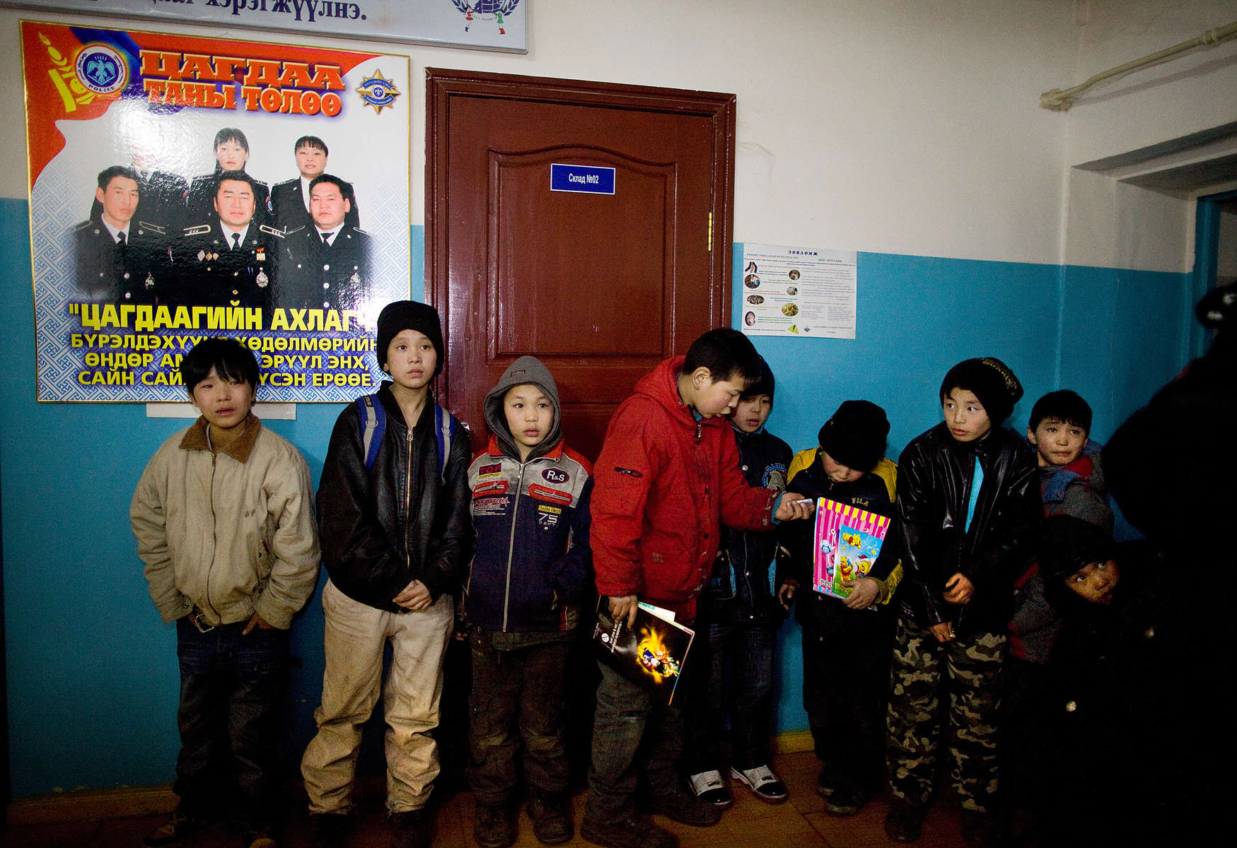 ULAAN BAATAR, MONGOLIA-MARCH 11 :  Mongolian street kids wait in line to get registered at the child detention center March 11, 2010  in Ulaan Baatar, Mongolia. The police picked up a dozen boys to get them off the streets in the cold weather housing them at the Ulaan Bataar Child Welfare/ detention center sponsored by World Vision. There about 45 kids live in the dormitory where they get hot food, showers, and some educational activities until their parents claim them. Before the children can go into more permanent shelters they are kept in the welfare center for up to 6 months. After that the state labels them as being abandoned or orphaned. Mongolia suffers with a very high number of alcoholics, all consuming cheap Mongolian vodka that is readily available to the poor and the unemployed, Many Mongolians have immigrated to the capitol city from the far away provinces seeking employment, living in rented traditional circular felt yurts with no running water or electricity. The problem is severe causing the number of street children to rise,  fleeing their abusive, dysfunctional homes. Some children are regularly beaten at home, and for the impoverished it is common to send the child out to make money. During the winter this means extreme hardship, the children out on the city streets are dealing with temperatures dropping as low as -25C mid- Winter. This year Mongolia has experienced the worst winter in 30 years. Presently the government has declared an emergency requiring foreign aid to alleviate the impact of the {quote} Zud{quote} ( Mongolian term for a multiple natural disaster) caused by bitter cold and thick snow that has effected 68% of the provinces. (Photo by Paula Bronstein /Getty Images)