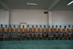 Mongolian wrestlers stand at attention before starting their practice at a local wrestling school. Mongolia is the most sparsely populated country on earth, but its people are some of the strongest. In Mongolia, wrestling is the most important sport that runs deep into its culture along with horsemanship and archery. Going back for hundreds of years, history books tell the story of how Genghis Khan considered wrestling to be an important way to keep his army combat ready while back in the Qing Dynasty (1646–1911) regular wrestling events were held. In Mongolia’s capitol city, Ulan Batar is home to many wrestling schools where almost daily you can see dozens of young men sweating in crowded gyms while in schools both girls and boys are taught some wrestling techniques.While my photo story gives a real behind the scenes look, it is unusual for a woman to document this macho scene of sweat and endurance.