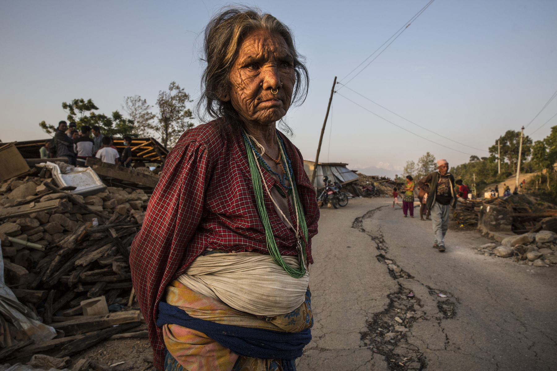 CHAUTARA, NEPAL -MAY 3, 2015:. A woman stands on a cracked road near the badly effected village of Chautara in the badly effected Sindhupalchok province  So far more than 7,000 people have died in Nepal\'s worst earthquake in 80 years.  (Photo by Paula Bronstein/ for the Wall Street Journal)
