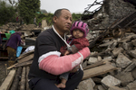 BARPAK, NEPAL -MAY 1, 2015:. Khem Ghale holds his son Milan,10 months who he rescued from his house as it collapsed. In Barpak where 60% of the village has been destroyed. The village is amongst the largest in Gorkha province with a population of around 10-12,000. Around 57-60 died. So far almost 6,000 people have died in Nepal\'s worst earthquake in 80 years.  (Photo by Paula Bronstein/ for the Wall Street Journal)