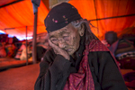BARPAK, NEPAL -MAY 1, 2015:. 99 year old Kalimaya Gurung rests under a tarp as her family clears debris in their homes. She refuses to leave her village, she was born in Barpak and chooses to die there. In Barpak 60% of the village has been destroyed. The village is amongst the largest in Gorkha province with a population of around 10-12,000, 57-60 died. So far almost 6,000 people have died in Nepal\'s worst earthquake in 80 years.  (Photo by Paula Bronstein/ for the Wall Street Journal)
